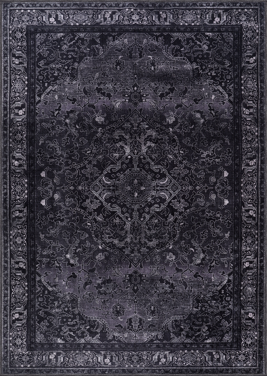 Dark gray area rug with intricate patterns on a matching background