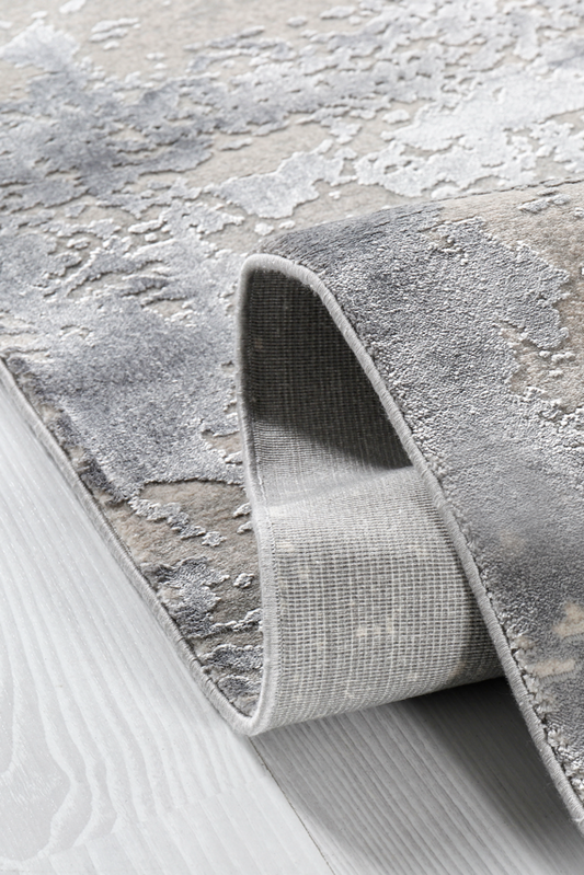 Roll of textured gray wallpaper on a light gray background