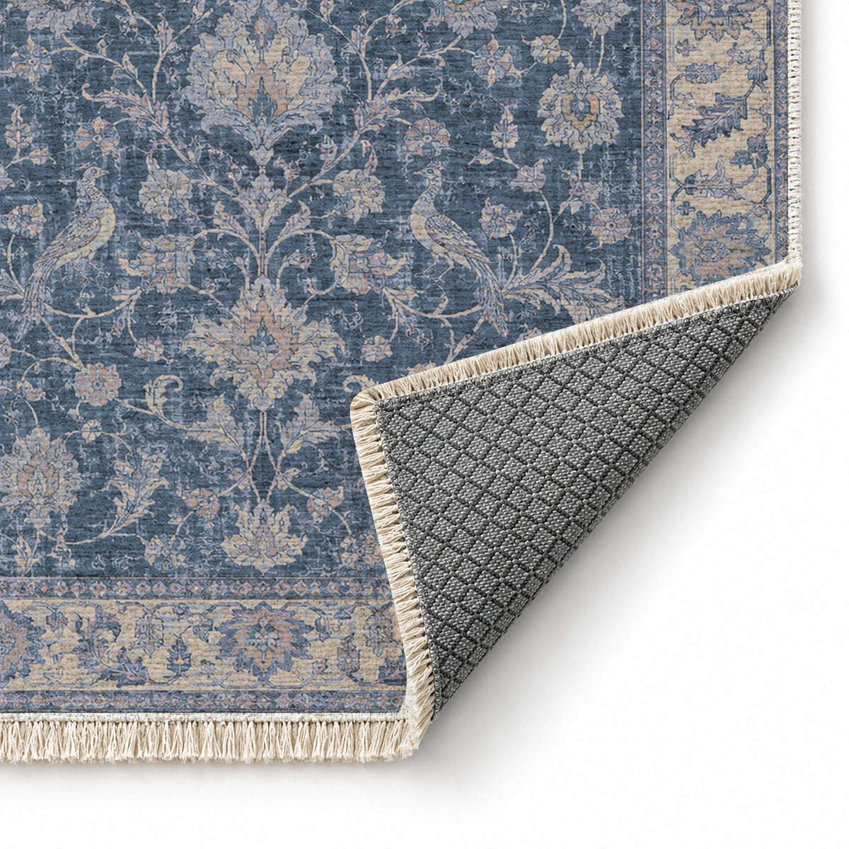 Bird Arabesque Mineral Blue washable rug folded corner showing the backing