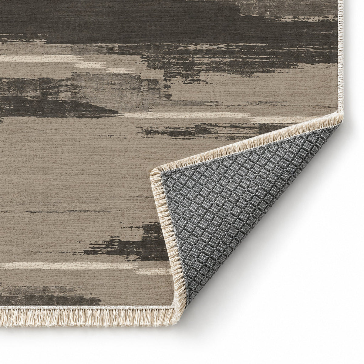 Broken Horizon Greige & Charcoal washable rug folded corner showing the backing