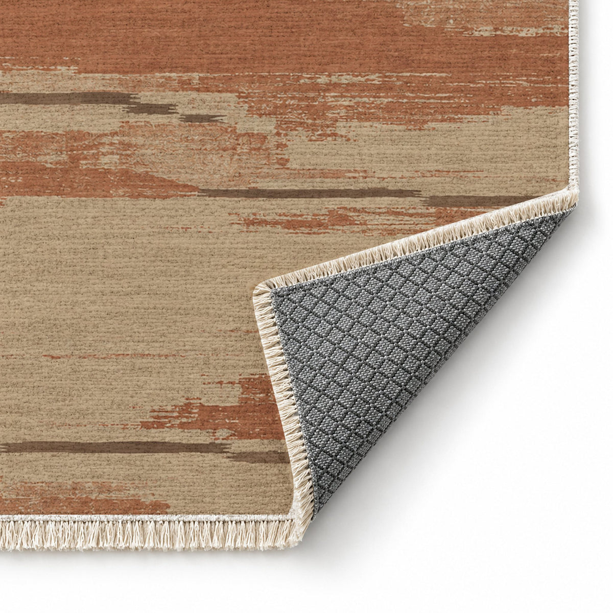 Broken Horizon Sand & Terracotta washable rug folded corner showing the backing