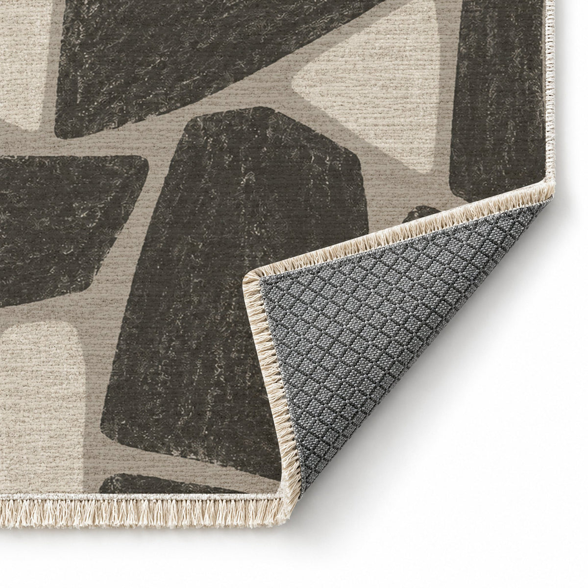Chalk Fragment Greige & Charcoal washable rug folded corner showing the backing