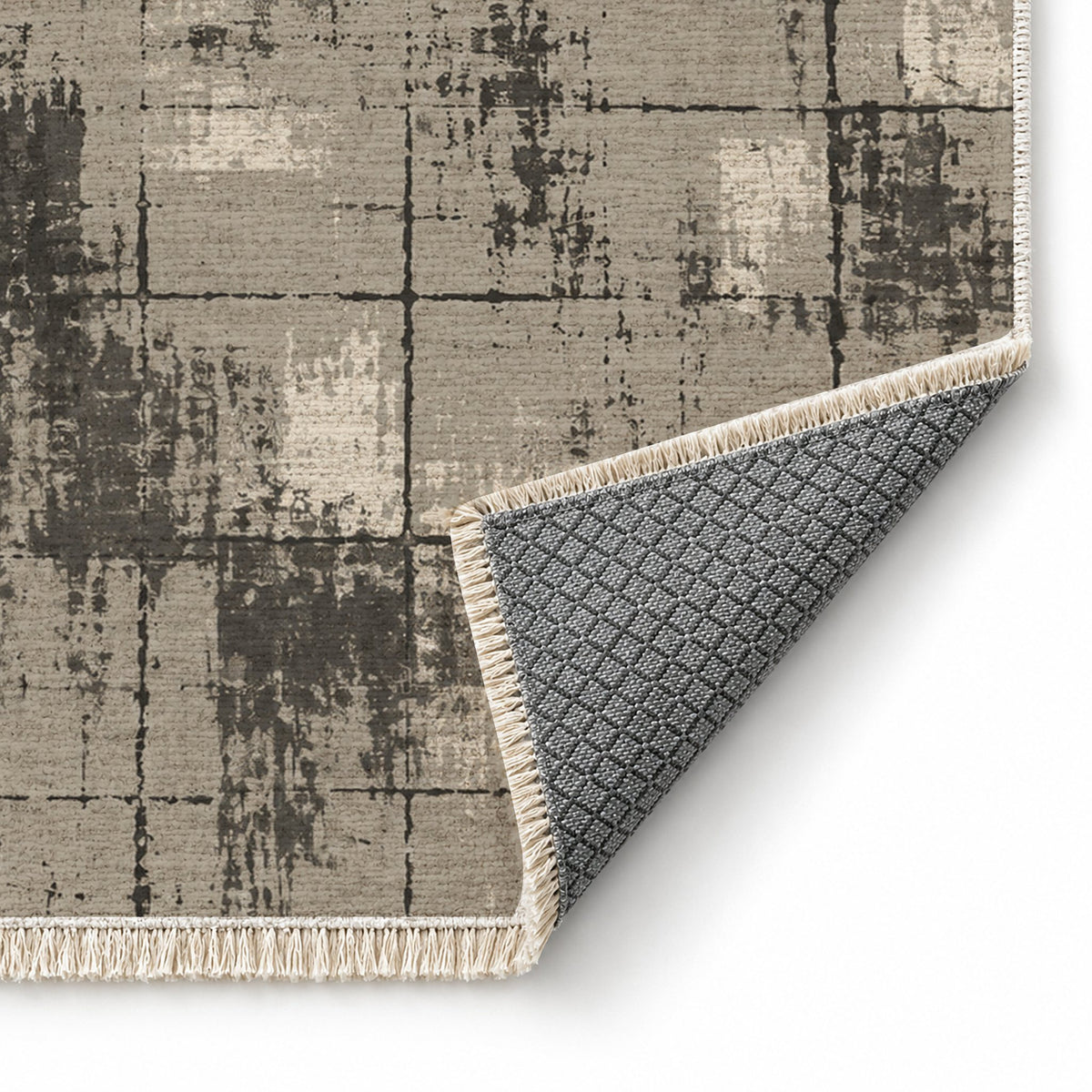 Faded Grid Greige & Charcoal washable rug folded corner showing the backing