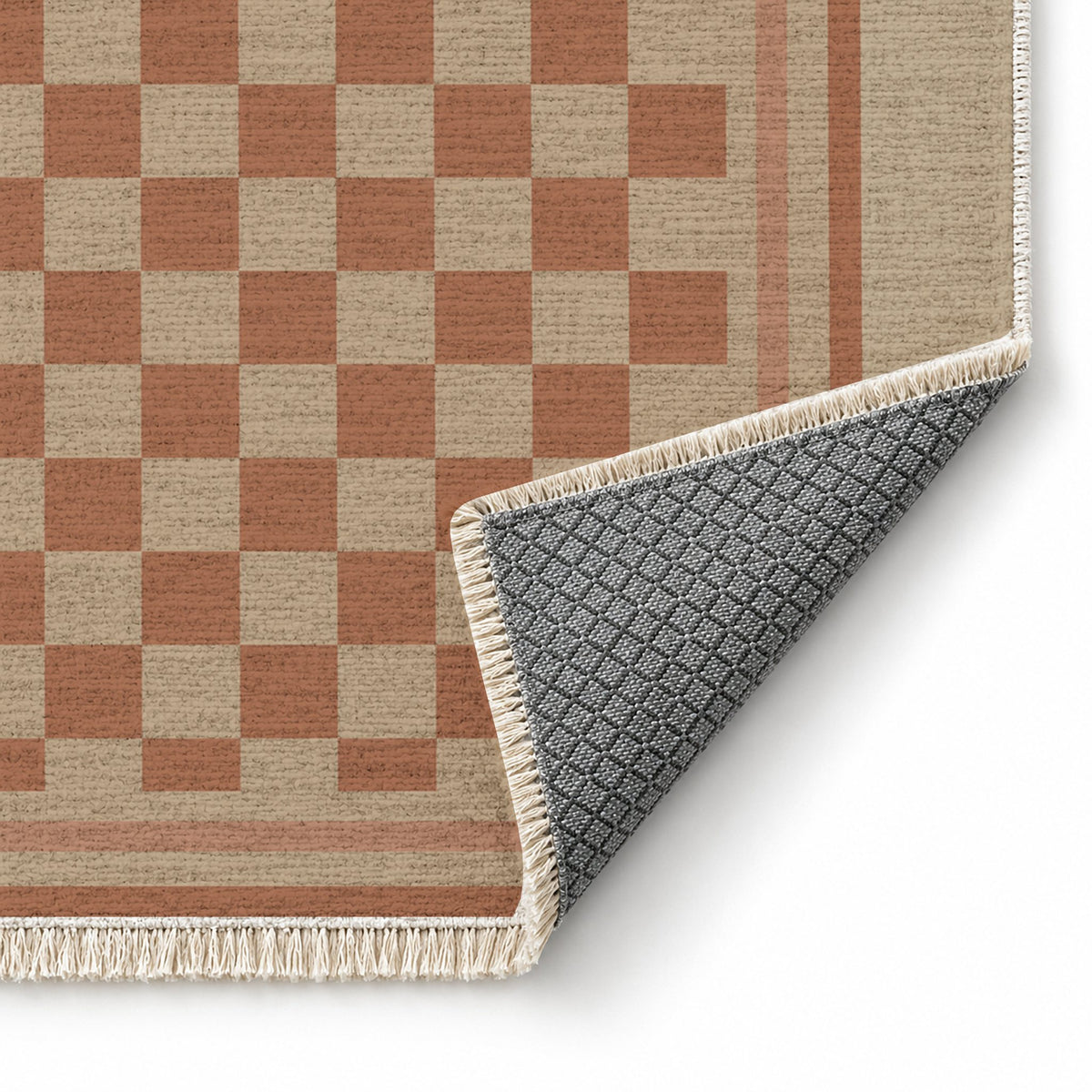Framed Check Sand & Terracotta washable rug folded corner showing the backing