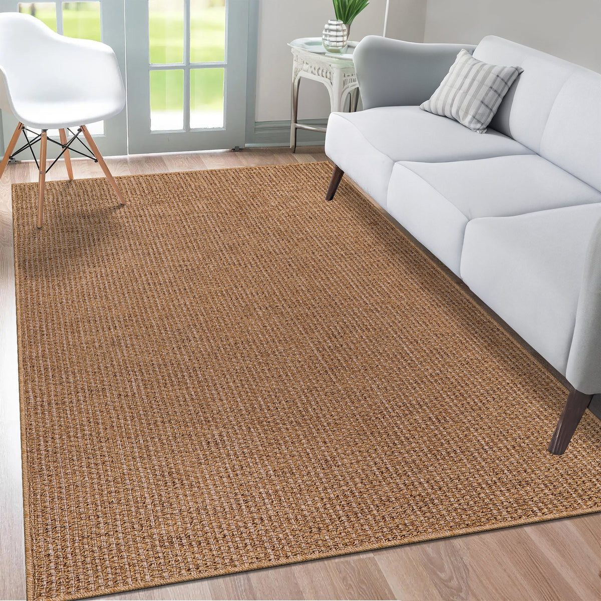Natural Herringbone Flatweave Indoor Outdoor Rug in a living room