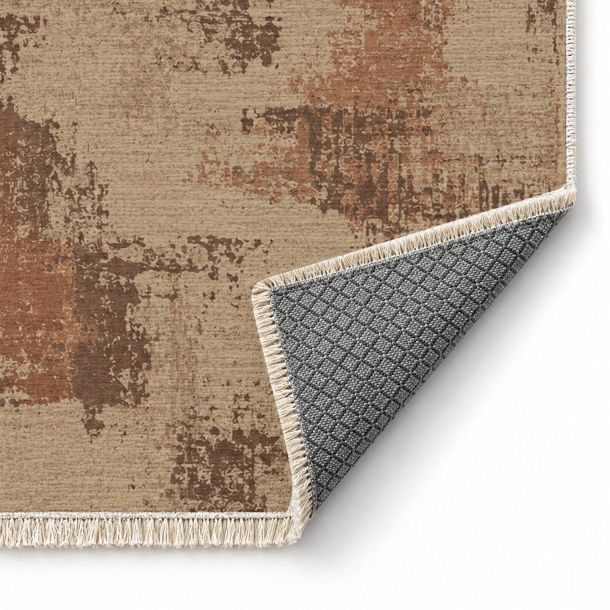 Patina Field Sand & Terracotta washable rug folded corner showing the backing