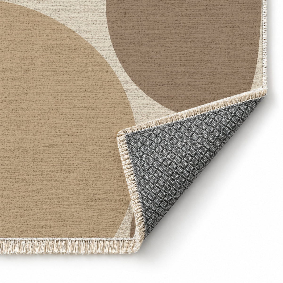 Pebble Forms Ivory & Sand washable rug folded corner showing the backing
