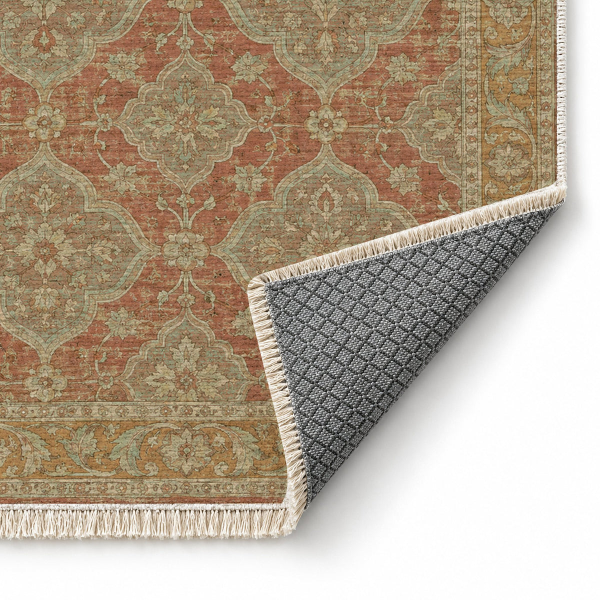 Quatrefoil Network Clay & Sage washable rug folded corner showing the backing