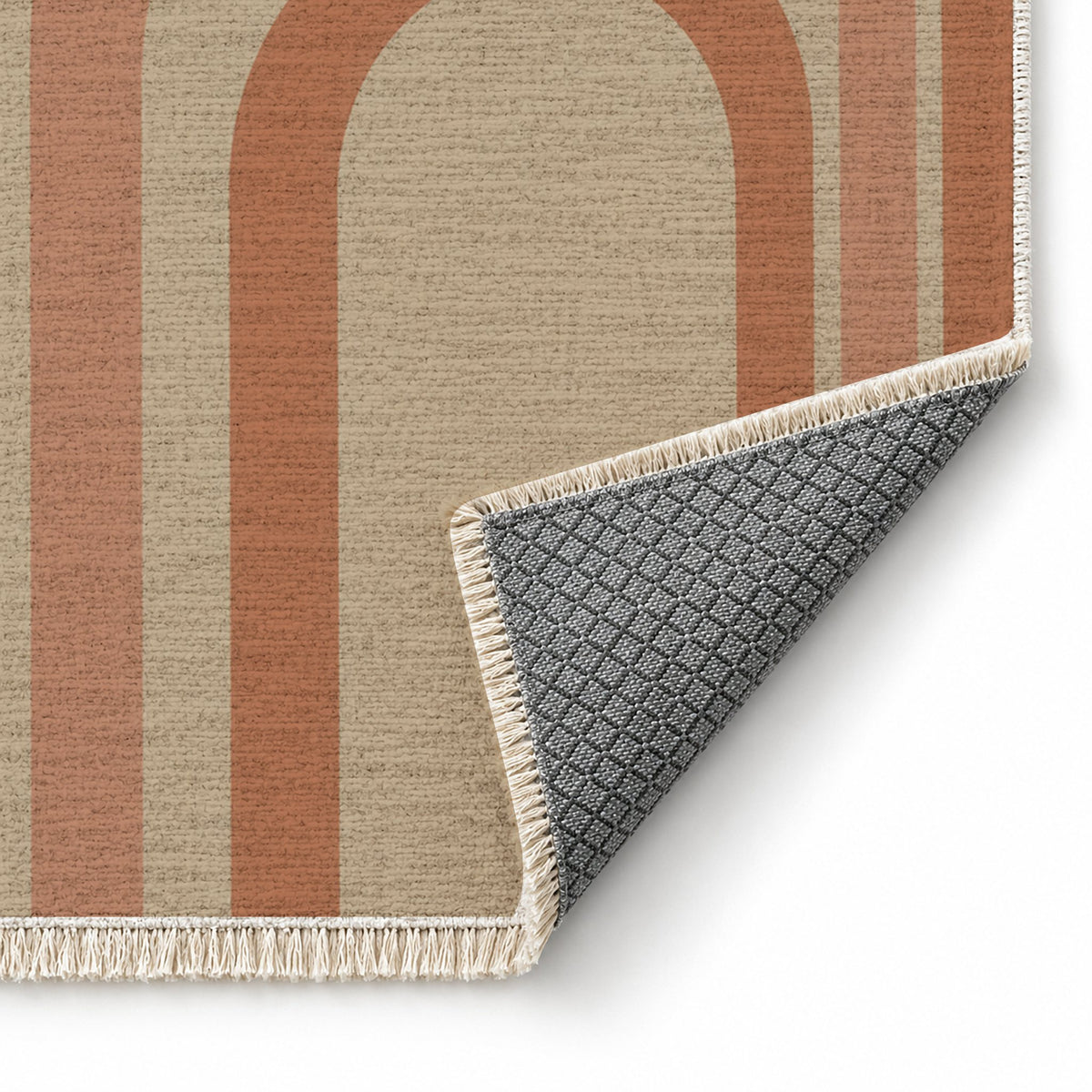 Quiet Arches Sand & Terracotta washable rug folded corner showing the backing