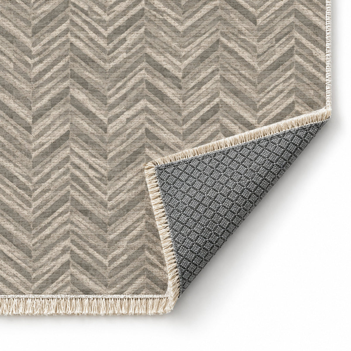Quiet Herringbone Greige & Stone washable rug folded corner showing the backing