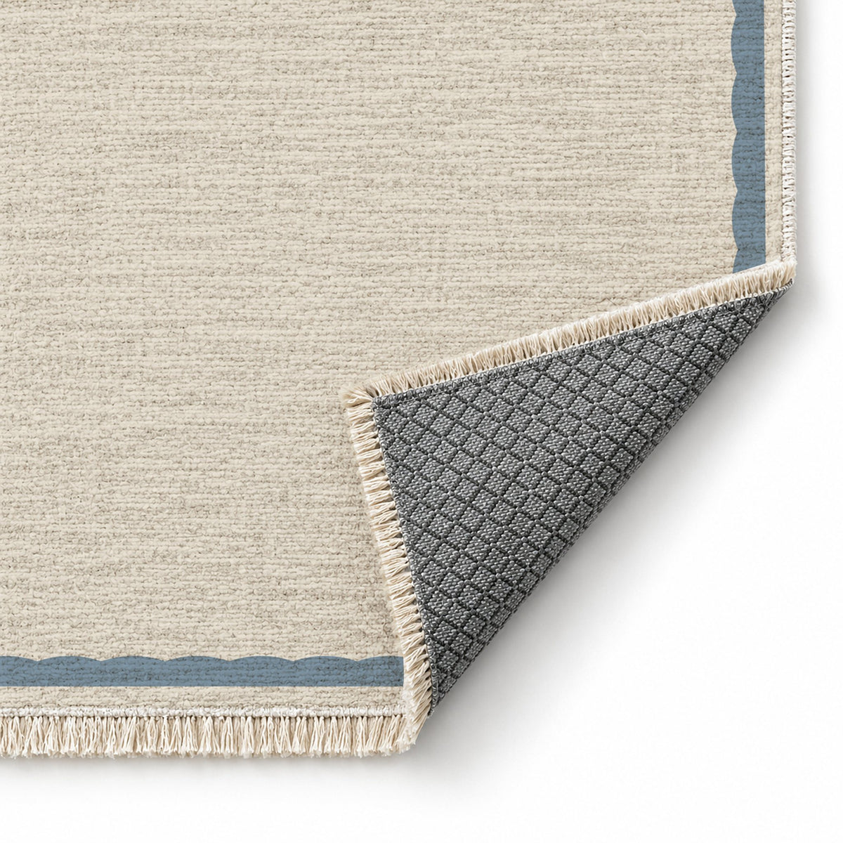 Soft Scallop Ivory & Dusty Blue washable rug folded corner showing the backing